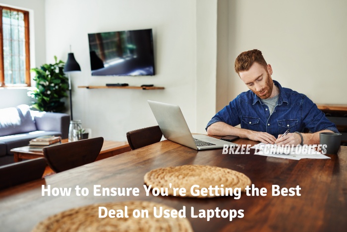 Man sitting at a dining table with a laptop and documents, representing thorough research on getting the best deal on used laptops. Trust BrZee Technologiees in Gandhipuram, Coimbatore, for top-quality pre-owned laptops and expert advice