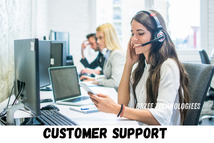 Smiling customer support representative at BrZee Technologiees in Gandhipuram, Coimbatore, providing expert assistance over the phone while using modern computer systems, ensuring top-notch service for all tech-related inquiries